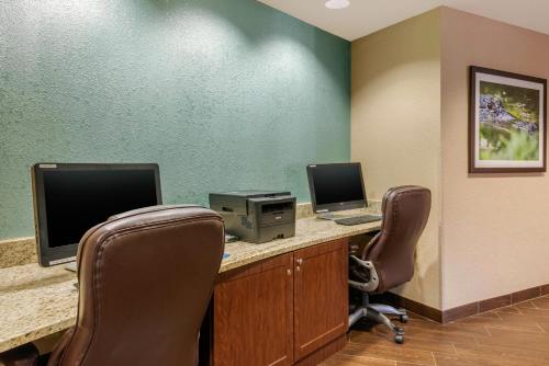 an office with two computer monitors and two chairs at Comfort Suites Lady Lake - The Villages in The Villages