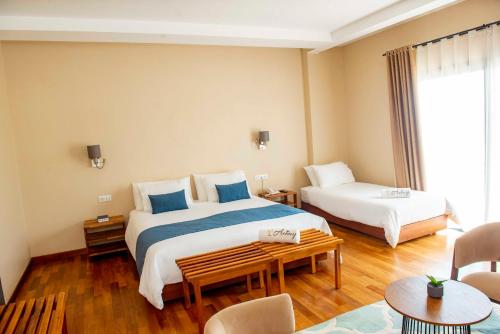 a hotel room with two beds and a table at Aviavy Hospitality and Special Events in Andakana