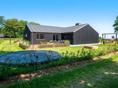 a house with a swimming pool in the yard at 12 person holiday home in Haderslev in Haderslev