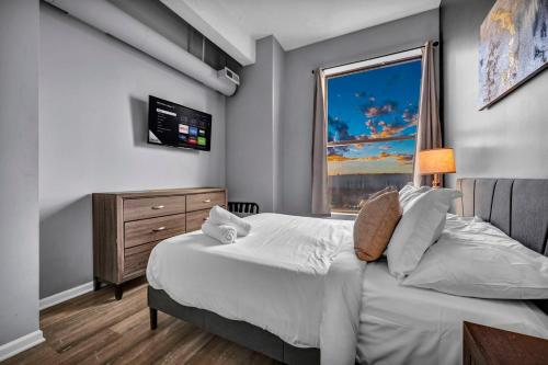 a bedroom with a large bed and a window at 1BR Loft Sauna & Walk to Theater & Campus in Cleveland