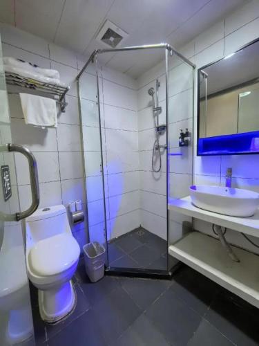 a bathroom with a shower and a toilet and a sink at 7 Days Inn Baoding Railway Station in Baoding