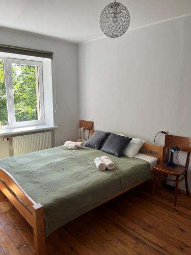 a bedroom with a bed with two towels on it at Barinu Street Apartment in Liepāja