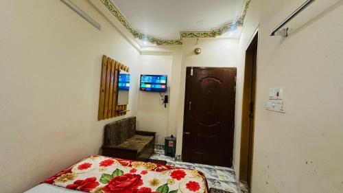 a bedroom with a bed in a room with a door at Hotel zam Zam Residential in Dhaka