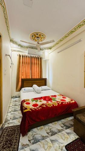 a bedroom with a bed with a red blanket at Hotel zam Zam Residential in Dhaka