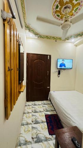 a room with a door and a tv on the ceiling at Hotel zam Zam Residential in Dhaka