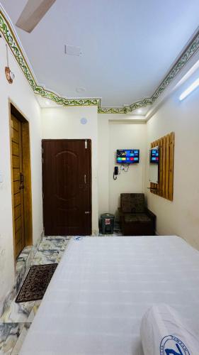 a bedroom with a large bed and a couch at Hotel zam Zam Residential in Dhaka
