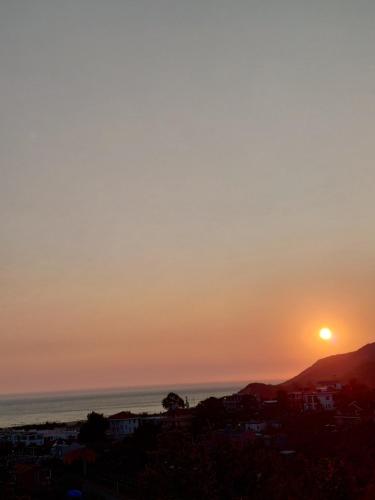 a sunset over the ocean and a city at Hotel Lalez Durres in Durrës