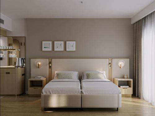 a bedroom with two beds and two night stands at Side Star Beach Hotel - Ultra All Inclusive in Side