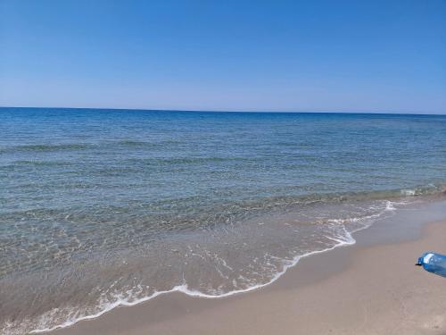 a sandy beach with the ocean in the background at Hotel Lalez Durres in Durrës