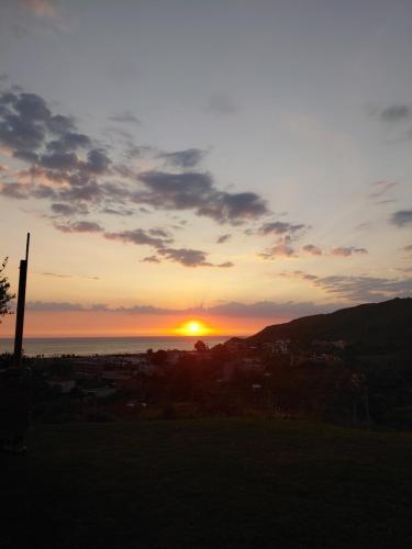 a sunset with the sun setting over a city at Hotel Lalez Durres in Durrës