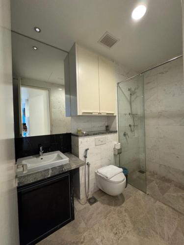 a bathroom with a toilet and a sink and a shower at THE PLATINUM KLCC by COZY STAY in Kuala Lumpur