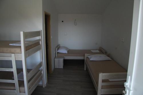 a small room with two bunk beds and a ladder at Bed & Breakfast Novalja Inn in Novalja