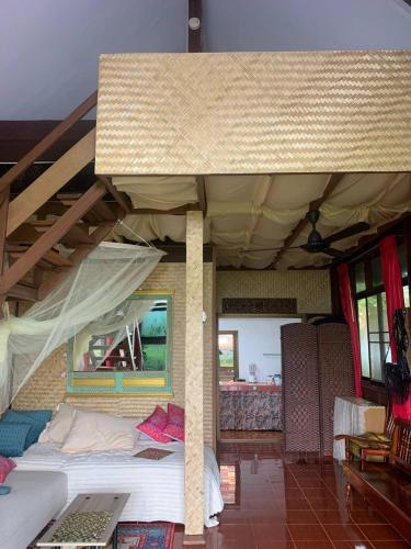 a room with a large bed in a house at Serenity Beachfront Bungalow Ko Samui in Amphoe Koh Samui