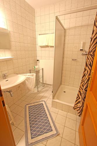 a bathroom with a shower and a sink at CProoms24 in Miesenbach