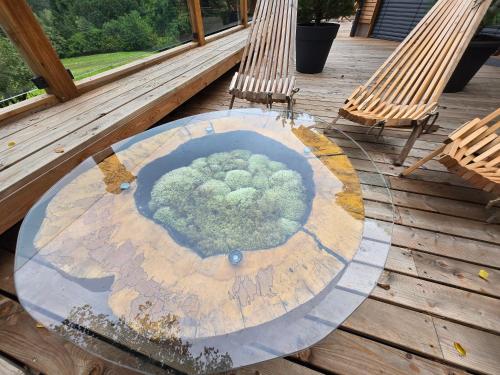 a round table on a deck with two chairs at Savinjski raj in Mozirje
