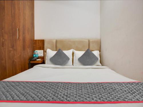 a bedroom with a large bed with two pillows at Hotel Ludhiana Regency in Ludhiana