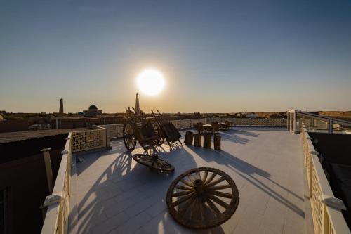 a carriage sitting on top of a roof at Potter Hotel Khiva in Khiva