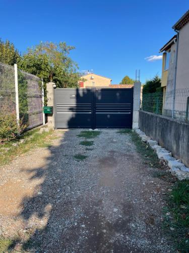 a garage with a gate in a driveway at Chez Carla in Sisteron
