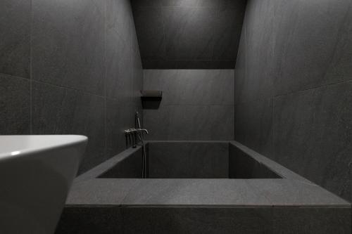 a bathroom with a bath tub and a sink at Stay Passport Airplane Guri in Guri