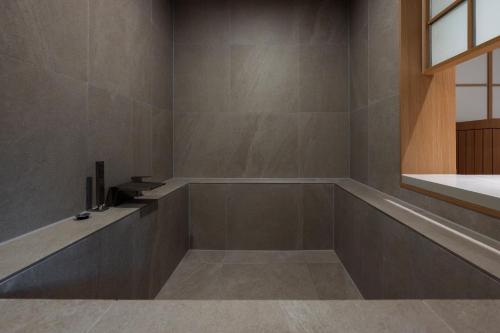 a bathroom with a tub and a sink at Stay Passport Airplane Guri in Guri