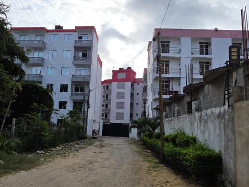 an empty street in a city with tall buildings at Stayswithyezzy in Mtwapa