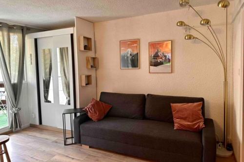 a living room with a couch and a window at Apartment for 4 near the slopes in Chantemerle in Saint-Chaffrey