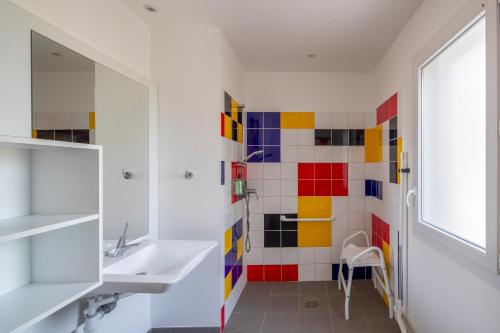 a bathroom with a sink and a mirror at Village Vacances passion La Buissière in Labeaume