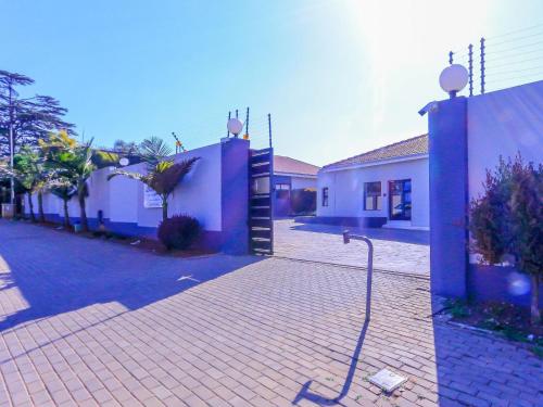a building with a hose attached to a brick street at Skylight Guest Lodge in Johannesburg