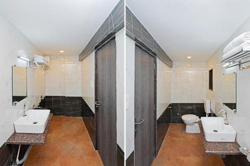 a bathroom with two sinks and two toilets at Hotel O Ashwarya Service Apartment in Navi Mumbai