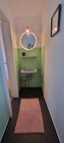 a bathroom with a sink and a mirror at Zu Gast im Denkmal St Peter in Dormagen