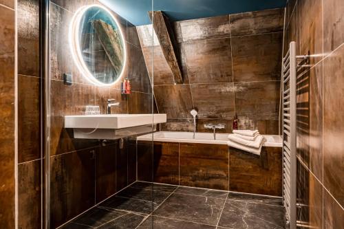 a bathroom with a sink and a mirror at MAF Haarlem Boutique Hotel in Haarlem