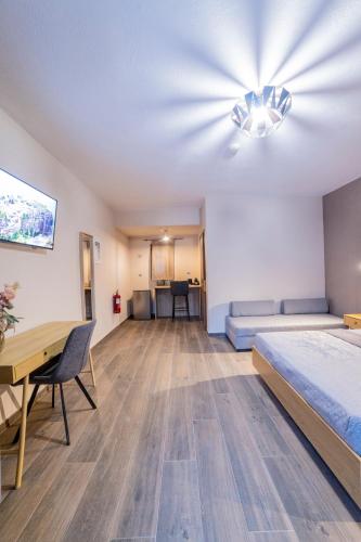 a bedroom with a bed and a desk and a table at Meteora Living Rooms in Kastrákion