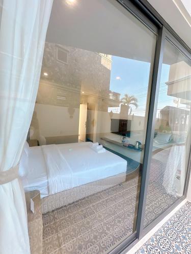 a bedroom with a bed and a view of a pool at Cham Charm Home Mui Ne in Mui Ne