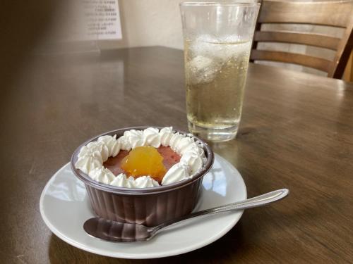 a cake on a plate next to a glass of water at Natural Mystic - Vacation STAY 04417v in Itoshima