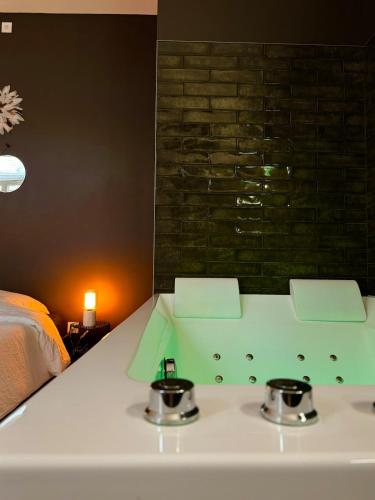a bathroom with a sink with two pots on it at Appart Spa hypercentre in Lille