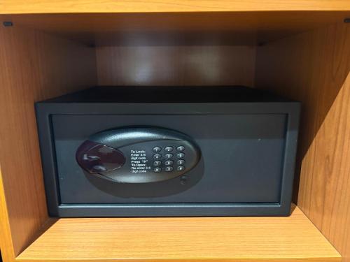 a microwave in a wooden cabinet with a drawer at Hotel RH Sorolla Centro in Valencia