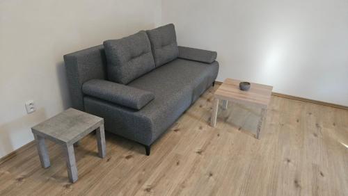 a living room with a couch and a table at Olšany Home - útulný domek se zahradou a parkováním u Olomouce - house with garden and parking near Olomouc 