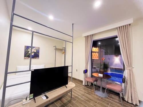a living room with a large flat screen tv at Cham Charm Home Mui Ne in Mui Ne