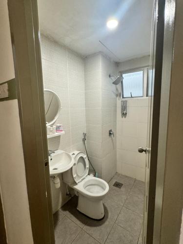 a bathroom with a toilet and a sink at AYAAN Luxe Premium FIFA house with Free WiFi and Netflix in Tanah Rata