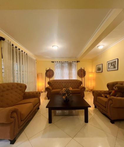 a living room with two couches and a coffee table at Villa Monza in Kandy