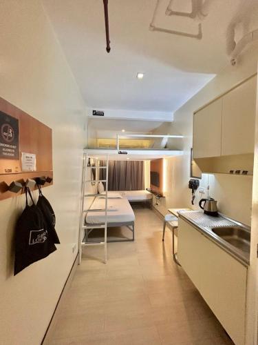 a small room with a kitchen with a table and a couch at Selah Lofts Hotel in Manila