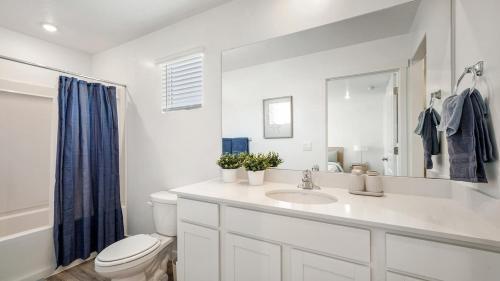 a white bathroom with a sink and a toilet at Family-Friendly 3-Story Home Sleeps 8 in American Fork