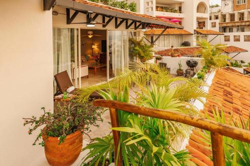a balcony with potted plants on a building at Luxury Oceanview Condo with heated Pool in Puerto Vallarta
