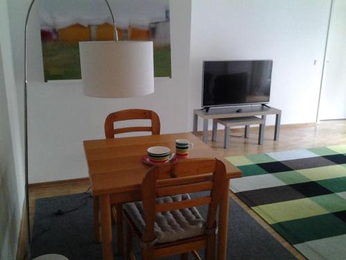a living room with a table and a television at K9 Wohnungen in Münster