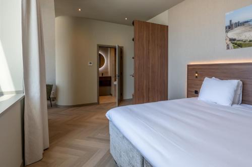 Ένα ή περισσότερα κρεβάτια σε δωμάτιο στο Hotel De Zeevaartschool