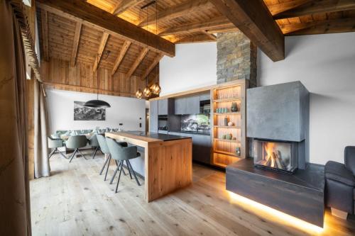 a kitchen with a fireplace and a dining room at Das Grabnergut in Bad Hofgastein