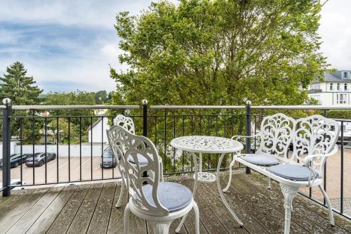 a patio with a table and chairs on a balcony at Wohnung Wilma - Villa Wiederkehr in Ostseebad Sellin