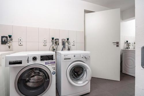 a white laundry room with a washer and dryer at Wohnung Wilma - Villa Wiederkehr in Ostseebad Sellin