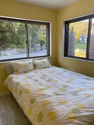 a bedroom with a bed and two windows at Hoshizora Terrace Minamiizu - Vacation STAY 08878v in Minamiizu