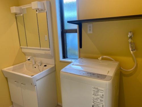 a bathroom with a washing machine and a sink at Hoshizora Terrace Minamiizu - Vacation STAY 08878v in Minamiizu